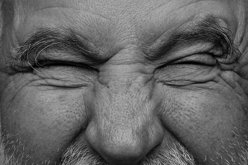 The scream in the old man's eyes. A black and white picture.