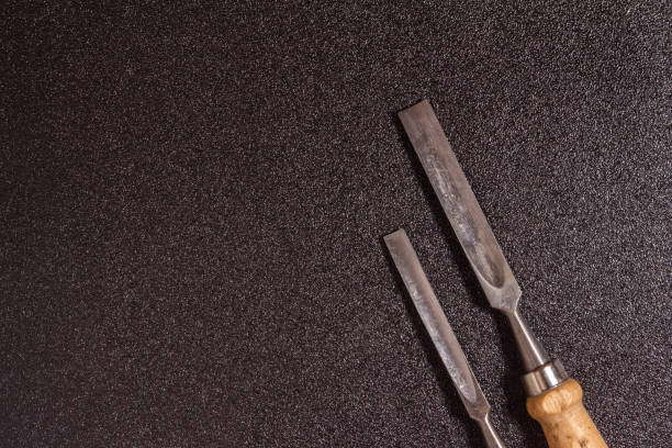 istock flat lay two wooden-handle chisel on a black speckled background top view 1460079033