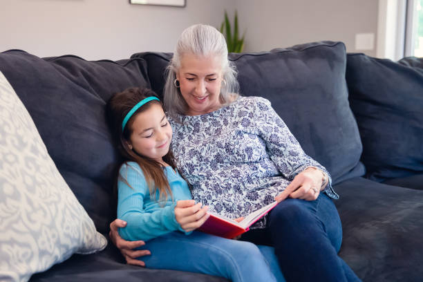 istock Grandmother and Granddaughter reading a book 1460079146