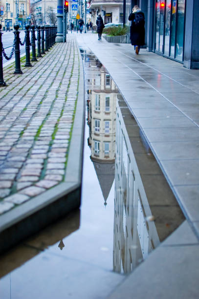 istock Old town tenement reflection in a puddle. 1460080192