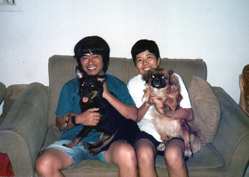 Portrait of mature couple with their dogs. This is a digitized old family picture