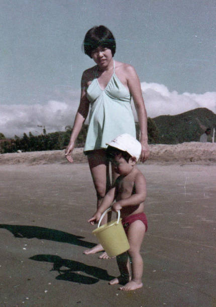 istock Young mother with her baby son on the beach 1460080312