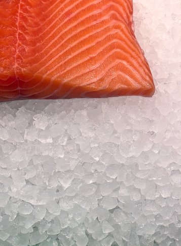 fresh salmon on ice for sale at the food market