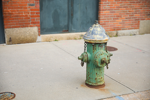 Old Fire Hydrant on the street stone cement sidewalk