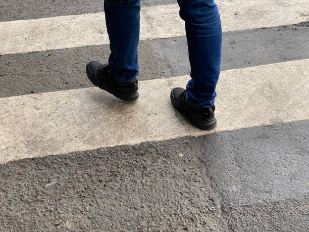 istock Feet walk across zebra crossings 1460088610