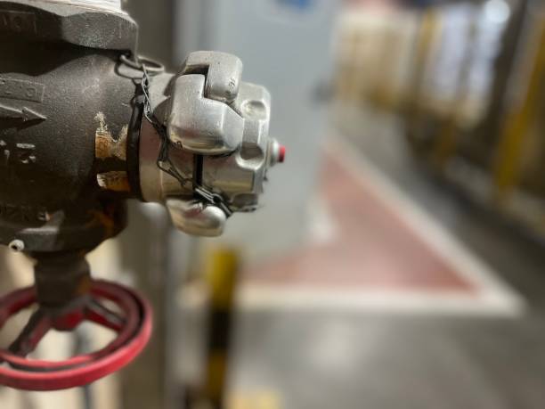 istock Water intake for fireman's hose with a red stopcock. 1460091671