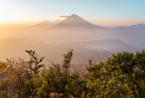 Volcan Acatenango and Volcan Fuego, Guatemala during golden hour on a warm summer day with vegetation in foreground