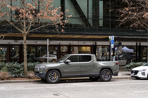 Seattle, USA – Jan 3rd, 2023: An electric Rivian truck parked at the Amazon Spheres campus late in the day.
