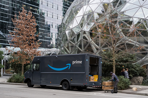 Seattle, USA – Jan 3rd, 2023: The 1st Amazon Go store with a Prime delivery van at the Spheres campus late in the day.