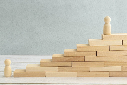 Strat, step and goal symbol. Concept words Start step 1 2 3 goal on wooden blocks on a beautiful blue table blue background. Businessman hand. Business start step 1 2 3 to goal concept.