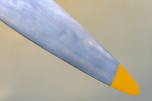 propeller blade with the tip painted yellow from an old single-engine plane