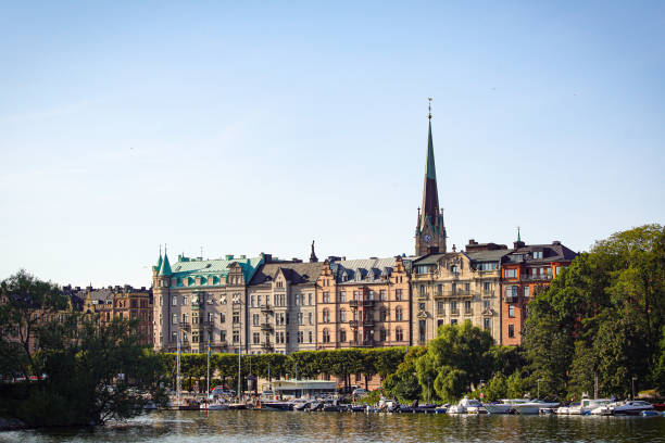 istock View of buildings by river against clear sky 1460098996