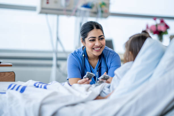 Nurse Checking on a Patient stock photo