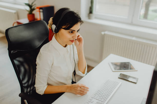 istock Young operator woman with headsets working in a call centre 1460117319