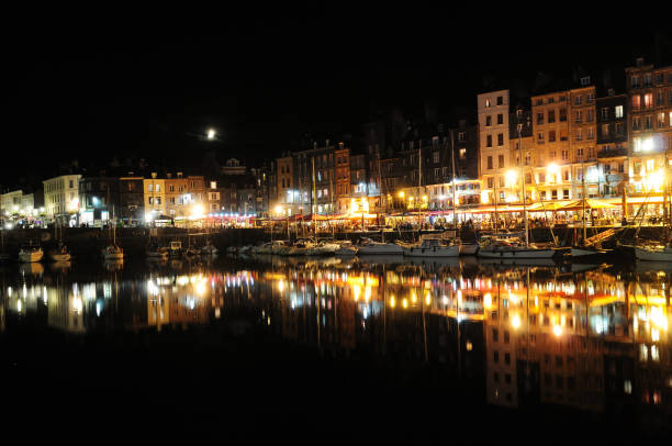 istock Night Scenery In The Historic Harbour With Brightly Lit Quay Saint-Etienne In Honfleur Normandy France 1460117334