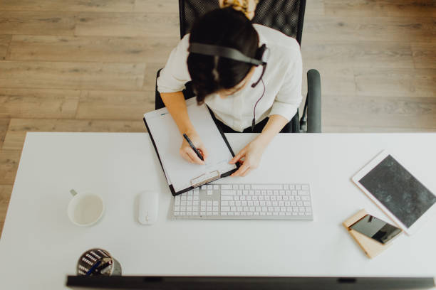 istock Top view of a female customer support agent working in her office 1460117343