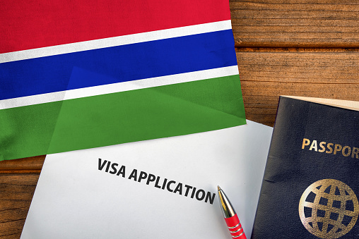 Visa application form, passport and flag of Gambia