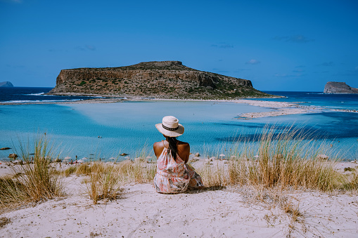 Balos Beach Crete Greece, Balos beach is one of the most beautiful beaches in Greece on the Greek Island, a woman with a hat looking at ocean