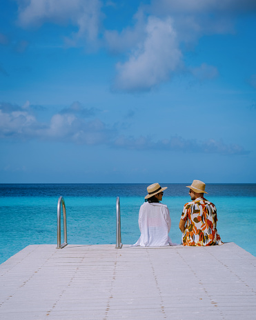 a couple visit Playa Porto Marie beach Curacao, white tropical beach with turqouse water ocean, couple men and women on vacation in Curacao