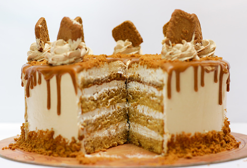 selective focus of biscoff butter cake. Biscoff layer cake isolated on white background.
