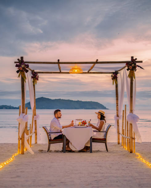 istock couple having a romantic dinner on the beach of Phuket Thailand 1460126596