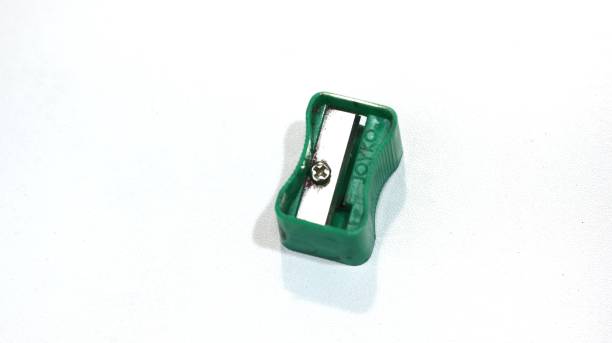 istock used pencil sharpener, green, small, dirty, rusty. sharpener isolated white background. copy space. 1460128569