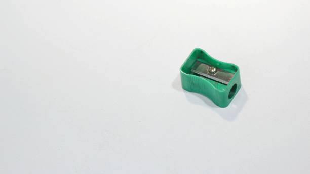 istock used pencil sharpener, green, small, dirty, rusty. sharpener isolated white background. copy space. 1460128570