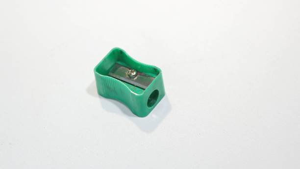istock used pencil sharpener, green, small, dirty, rusty. sharpener isolated white background. copy space. 1460128576