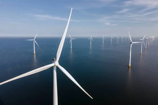 Wind turbine from an aerial view, Drone view at windpark a windmill farm in the lake IJsselmeer the biggest in the Netherlands, Sustainable development, renewable energy.
