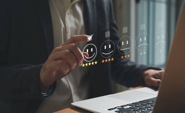 istock Selective focus at finger of business man while point finger to choose feedback on excellent customer service with five star score with smile. Service evaluation concept with futuristic icon. 1460149357