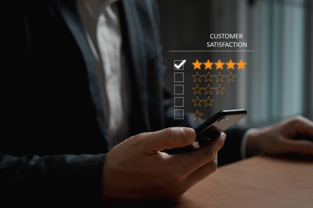istock Selective focus at finger of business man while point finger to choose feedback on excellent customer service with five star score with smile. Service evaluation concept with futuristic icon. 1460149377