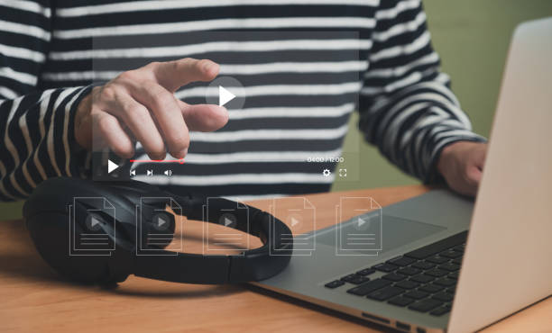 istock Selective focus at finger that push on press play button for start online entertainment for on demand video streaming service that online over internet which include movie or music. 1460150212