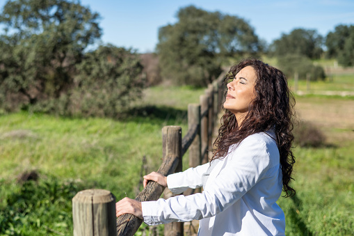 Woman Breathing Fresh Air Outdoors In Spring