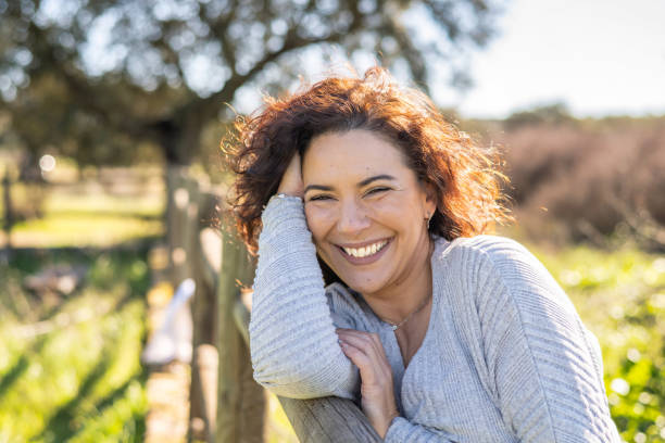 istock Happy Woman Smiling At Camera In A Field 1460151481