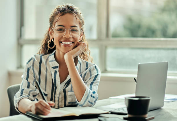 istock Notebook, strategy and planning black woman with ideas, writing notes and writer vision office portrait. Copywriting person, employee business agenda or writing schedule of worker at her desk 1460159314