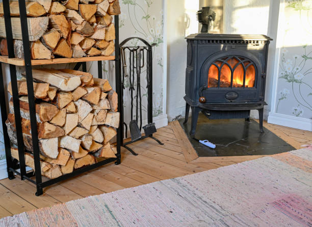 piled firewood near burning cast iron stove Kumla Sweden january 27 2023