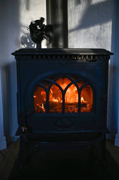 istock orange fire in old cast iron stove 1460163493