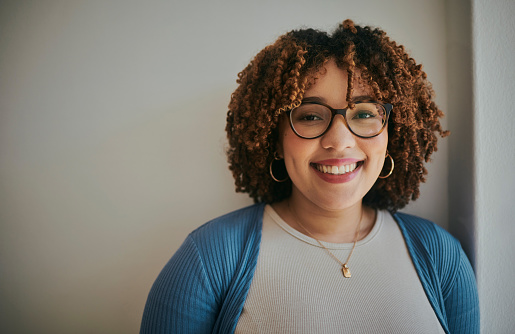 Portrait, black woman and happy corporate employee smile, relax and excited on background, wall and mockup. Face, girl and worker with vision for change, career and goal while standing in office