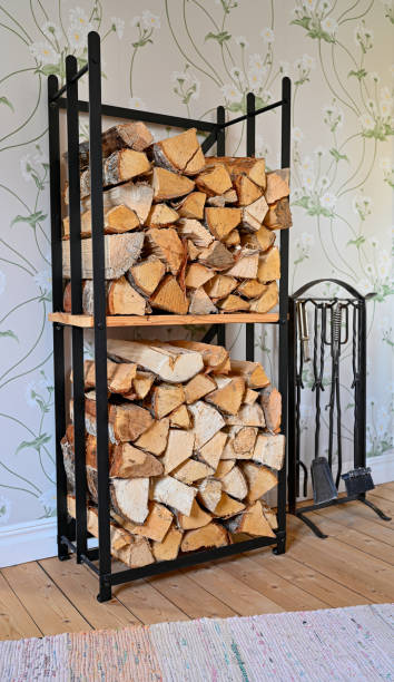 istock firewood piled indoors and stove tools hanging beside 1460164325