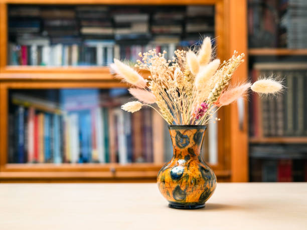 istock dried plants in vase on table with bookcase 1460165429