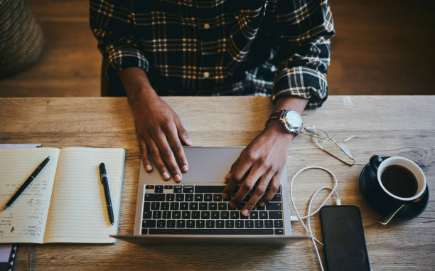 istock Black man, hands and computer typing of a employee with morning coffee writing code. Above freelancer, working and digital laptop research notes of a person writing digital research and job email 1460165719
