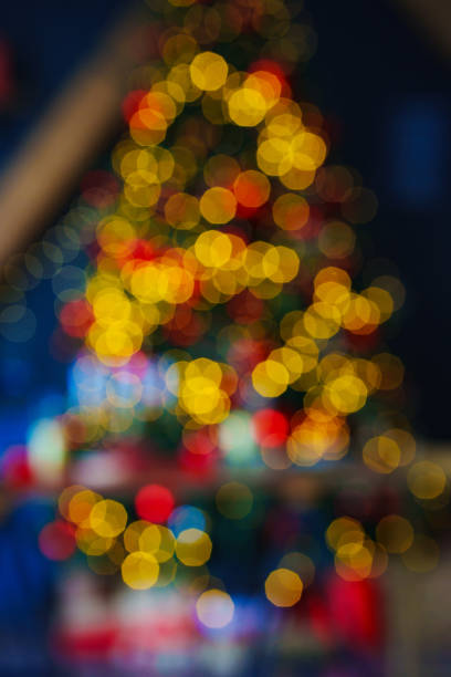 istock unfocused. a large Christmas tree decorated in a room with a black wall. blur 1460168962