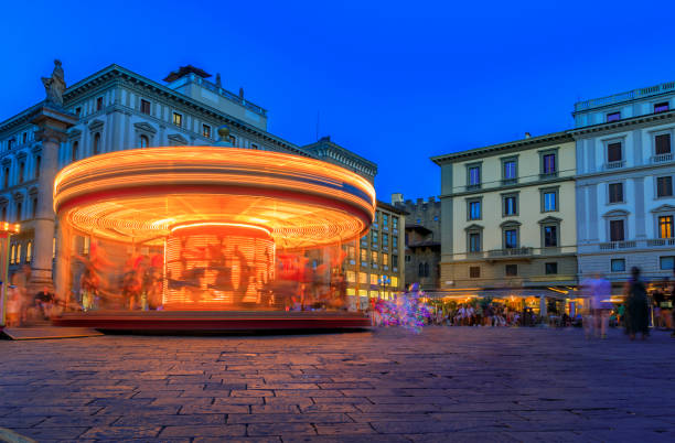 Photo of Illuminated antique carousel on Piazza della Republica, Florence Italy at sunset