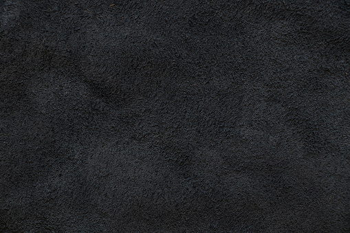 dark gray natural suede as a background close up