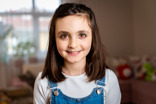 Headshot portrait of happy little girl posing