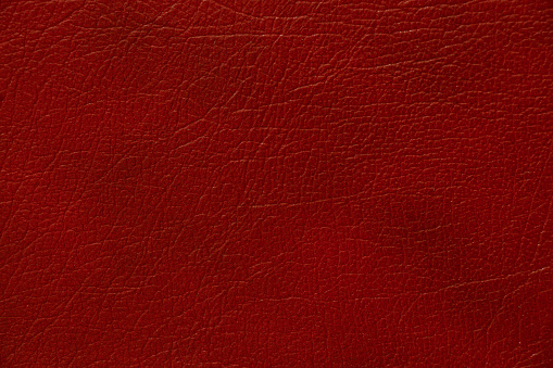 dark red genuine leather as a close up background