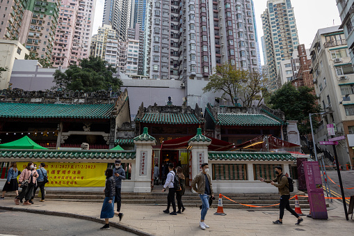 Hong Kong - January 27, 2023 : People at the Man Mo Temple Compound on Hollywood Road, Sheung Wan, which comprises three blocks, namely Man Mo Temple, Lit Shing Kung and Kung Sor, were built between 1847 and 1862.