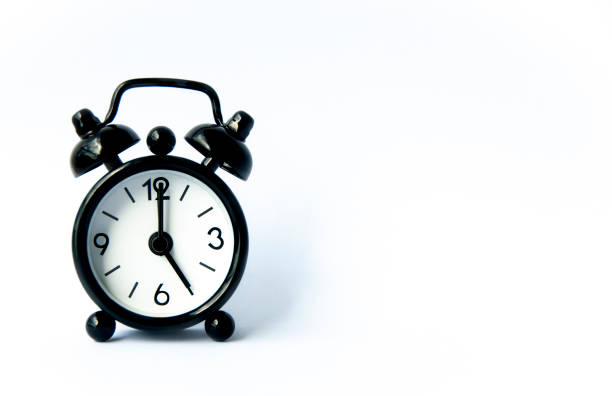 istock Black alarm clock pointing at 5 o'clock with customizable space for text on white background. Copy space and time concept. 1460175543