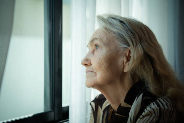 istock Lonely old woman Sit and look out the window 1460178853
