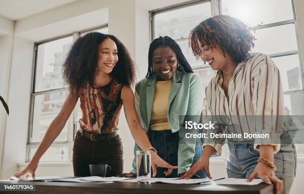 Teamwork Collaboration And Planning Black Women With Documents Paperwork Or Design Strategy In Office Business Startup Gender Equality And Marketing Ideas Of Diversity People In Workspace Meeting Stock Photo - Download Image Now